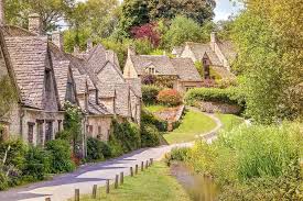 Picturesque Cotswolds village with honey-colored stone cottages and gardens